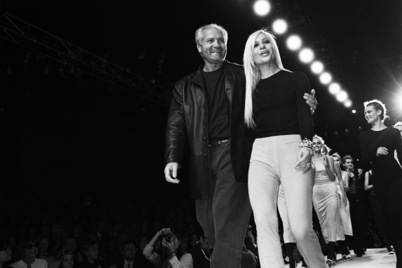 Donatella and her brother Gianni on the runway after a Versace fashion show in New York, 1996. 