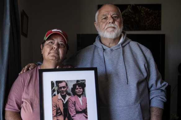 Kim May with her brother, Kenny, holding a photo of their late mother and father. They have serious concerns about the treatment of their mother, Gwendoline May, in a NSW hospital.  