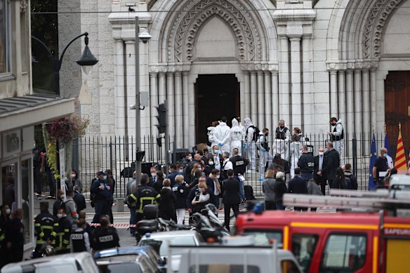 Police officers work at the Notre Dame church in Nice, southern France, after the attack.