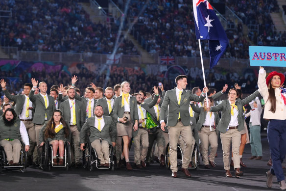 Eddie Ockenden and Rachael Grinham, flag bearers of Team Australia lead their team out during the opening ceremony of the Commonwealth Games wearing uniforms by RM Williams.