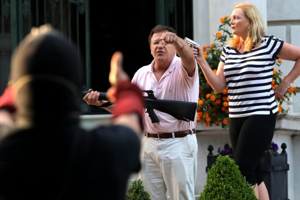 Mark McCloskey and his wife Patricia confronted protesters outside their home in St Louis. 
