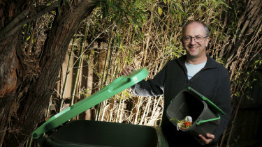 Glen Eira mayor Jamie Hyams putting out food scraps in the green waste bin for kerbside collection. 