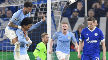 Leroy Sane (hand raised) celebrates his goal for Manchester City against Schalke 04.