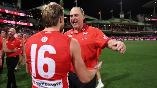 Swans coach John Longmire celebrates with Braeden Campbell.