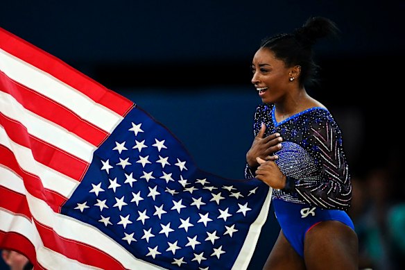 Simone Biles of the United States reacts after taking gold at the women’s all-round final.
