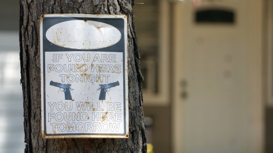 A warning sign outside the home where a mass shooting occurred on Friday night, in Cleveland, Texas. 