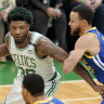 Boston Celtics guard Marcus Smart prepares to drive against Golden State Warriors star Stephen Curry.