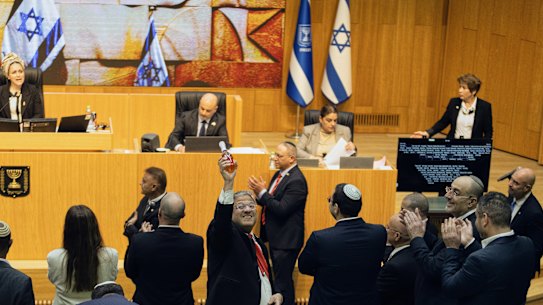 Israeli Minister of National Security, Itamar Ben-Gvir, centre, and lawmakers celebrate after Israel’s parliament passed a law approving the death penalty for Palestinians convicted of murdering Israelis on Momday.