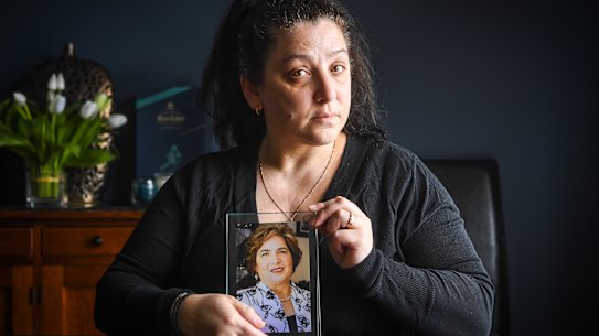 Klery Loutas, holding a photo of her mother Filia Xynidakis.