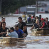 Volunteers help to evacuate residents from an area flooded by heavy rains, in Porto Alegre, Brazil, on Tuesday.