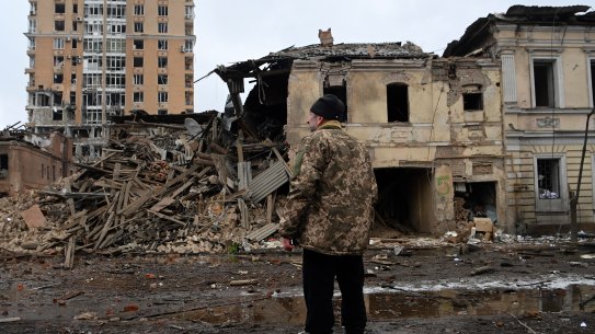 A man surveys the damage from a Russian air strike in Kharkiv. 