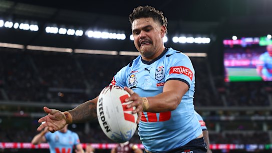 Latrell Mitchell celebrates scoring for the Blues.