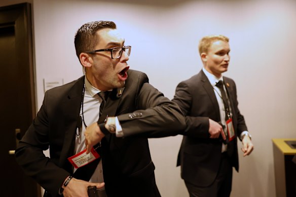 Secret Service agents draw their weapons in response to the shooting.