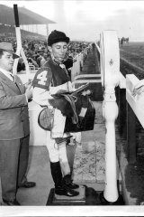 Australian jockey Neville Sellwood weighs in after winning a race in the US in 1951.