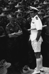 Captain Andrew Robertson addresses officers and men of the 5th Battalion RAR on the flight deck of HMAS Sydney at Garden Island, 1973.