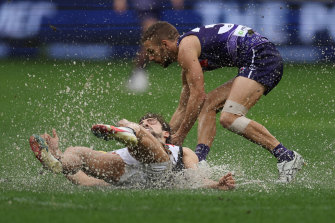 Josh Daicos of the Magpies and Sam Switkowski of the Dockers battle for the ball.