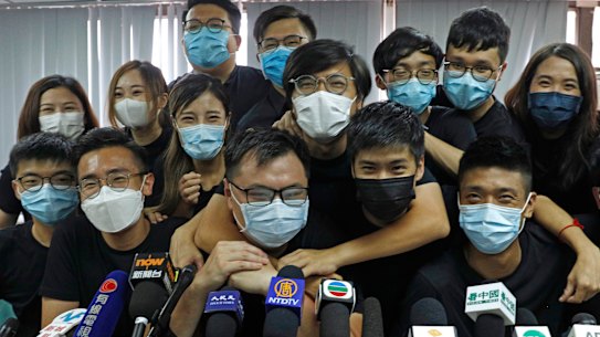 In this July 15, 2020, file photo, pro-democracy activists who were elected from unofficial pro-democracy primaries, including Joshua Wong, left, attend a press conference in Hong Kong. 