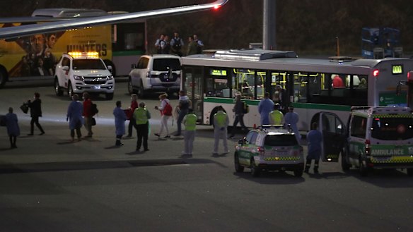 Healthy Artania cruise ship passengers boarding chartered flights at Perth Airport on Sunday night.