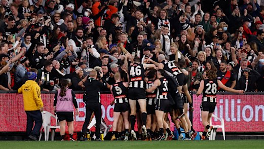 Collingwood players celebrate Jamie Elliott’s post-siren match-winner.