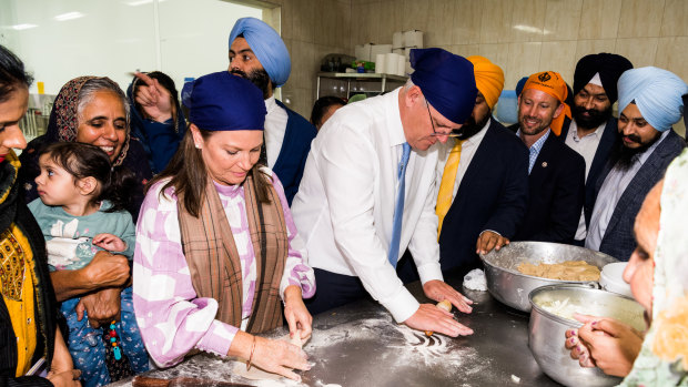 Prime Minister Scott Morrison and wife, Jenny, knead naan bread.