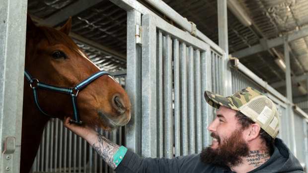 Returned serviceman Clayton Hellyer with retired racehorse Vashka ... “People think we save them. They saved me.”