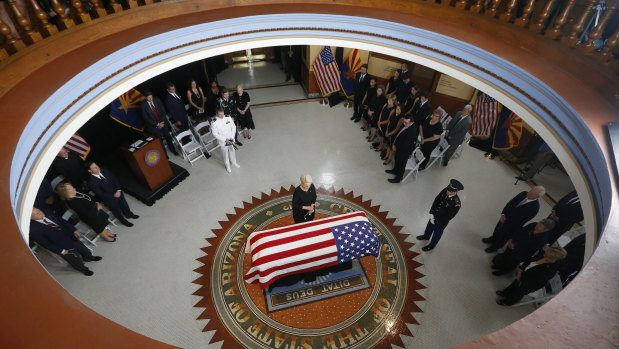 Cindy McCain, wife of John McCain, stands at the casket during a memorial service at the Arizona Capitol.