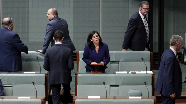 Julia Banks surrounded by government MPs as she announces her resignation from the Liberal Party following the August leadership spill.