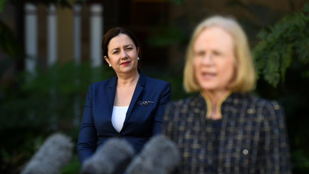Queensland Premier Annastacia Palaszczuk (left) watches Chief Health Officer Jeannette Young during a press conference at Parliament House in Brisbane.