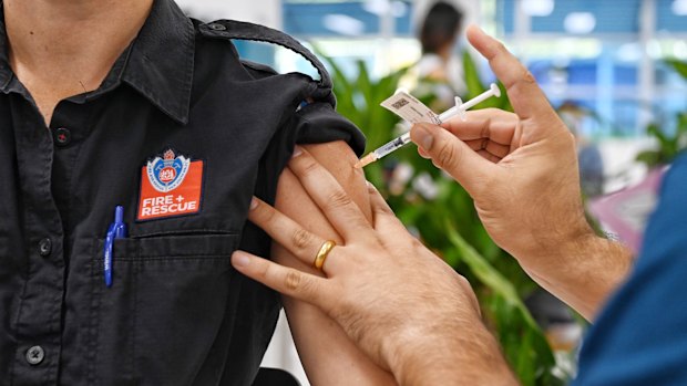 An emergency worker receives a COVID-19 vaccine at the new mass vaccination hub at Sydney’s Olympic Park.