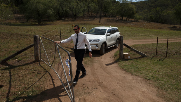 A police detective at the gate of the remote Doyles Creek property on Friday.