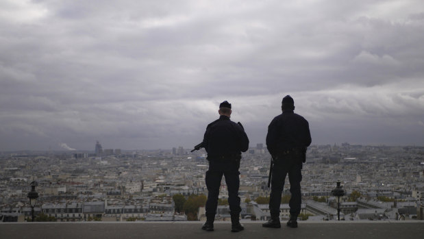 French police guard the Sacre Couer basilica in Paris as the nation's security alert status is set at its highest level. 
