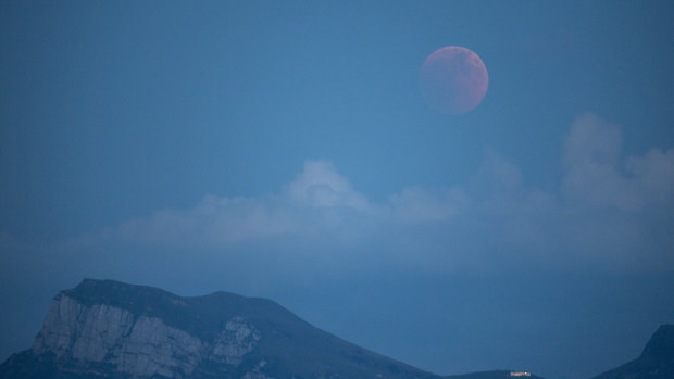 The moon turns red during a total lunar eclipse, as seen from Lucerne, Switzerland.