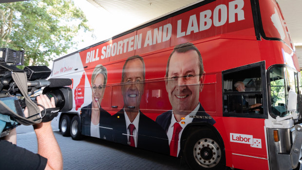 Bill Shorten arrives on his campaign bus – which bears the image of Premier Mark McGowan – before a visit to Royal Perth Hospital on Monday.