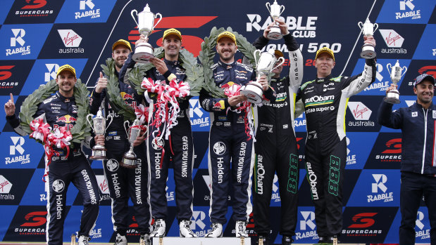 Three-up for Triple Eight: Jamie Whincup and Paul Dumbrell (centre), second-placed Shane van Gisbergen and co-driver Earl Bambe (left pair), with veteran pairing Craig Lowndes and Steven Richards rounding out the podium.