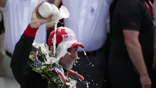 Will Power celebrates his win ... by dousing himself with milk.