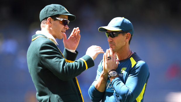 Toss up: Justin Langer looks to captain Tim Paine after Australia elected to bat – and change dressing sheds – in Perth.