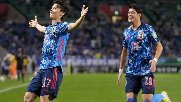 Japan’s Ao Tanaka, left, celebrates after scoring his team’s first goal.