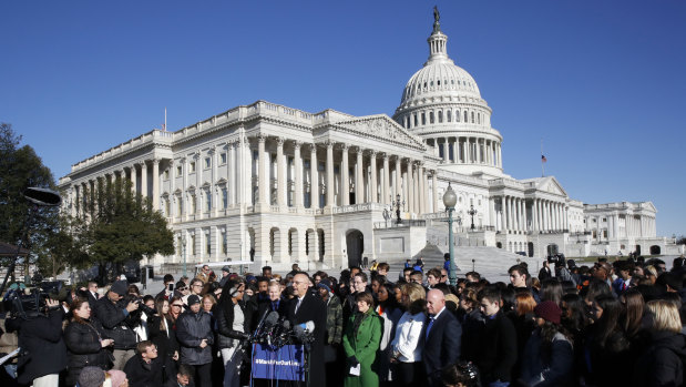 Florida Democrat Ted Deutch speaks at the podium on Capitol Hill during anti-gun demonstrations where he is joined by students and parents from Marjory Stoneman Douglas High School.