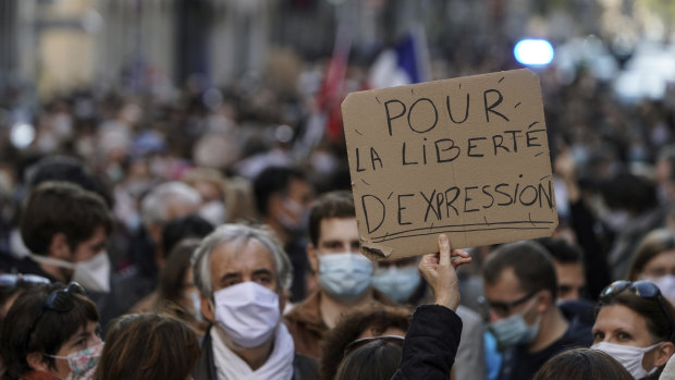 A protester's sign reads: 'For the freedom of speech', at a demonstration in Lyon, central France, after the beheading of history teacher Samuel Paty near Paris.