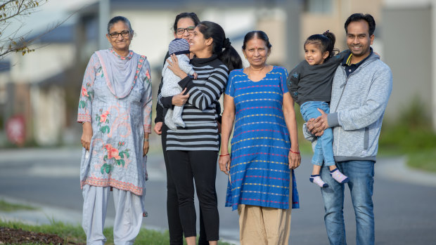 Prabhjot Kaur, centre) and Antish Vaghela (far right) with their families at Delaray Estate.