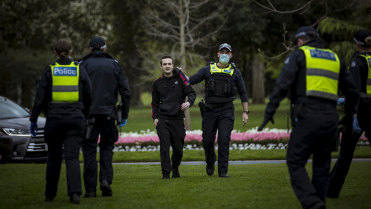 An anti-lockdown supporter is detained by Victoria Police.