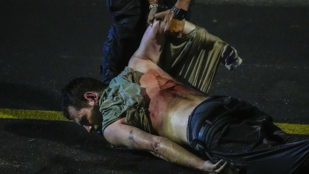 An injured demonstrator is dragged by police to be detained during a protest against plans by Netanyahu’s government to overhaul the judicial system, in Tel Aviv.