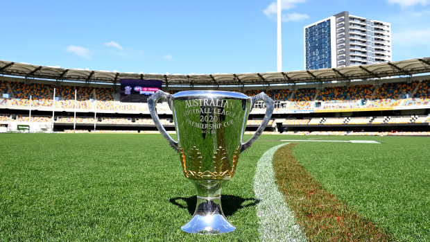 The AFL premiership cup gets comfortable at the Gabba.