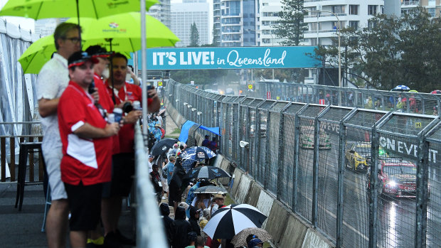 Rain on the parade: Gold Coast crowds take cover amid the downpour.