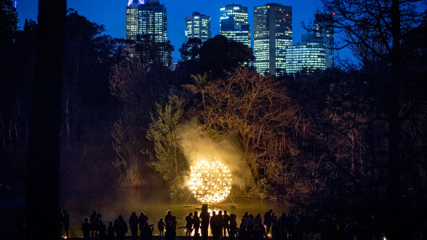 A spherical frame holds dozens of fire pots.