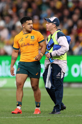 Hunter Paisami speaks with a physio ahead of leaving the field with concussion.