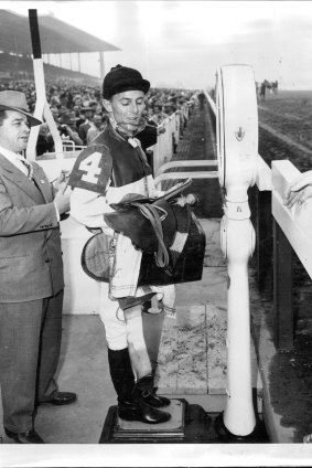 Australian jockey Neville Sellwood weighs in after winning a race in the US in 1951.