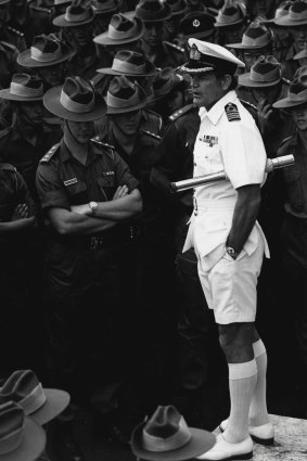 Captain Andrew Robertson addresses officers and men of the 5th Battalion RAR on the flight deck of HMAS Sydney at Garden Island, 1973.