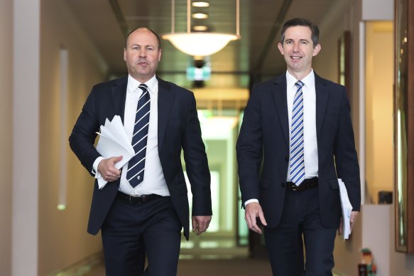 Treasurer Josh Frydenberg (left), with Finance Minister Simon Birmingham, has revealed the budget is on track to remain in the red for the rest of the decade.