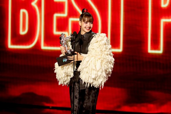 An emotional Lisa, of Blackpink fame, accepts the best pop award.